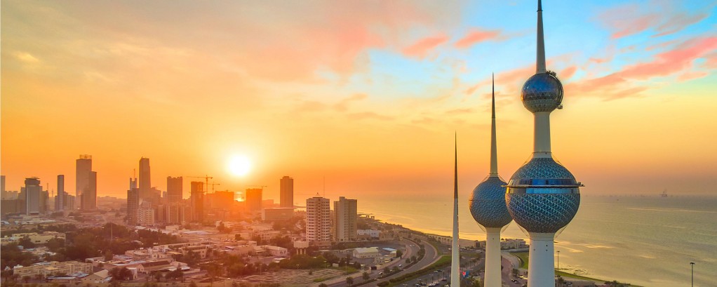 The Kuwait Towers overlooking the city in the sunset.